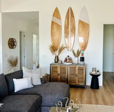 a living room with three surfboards mounted to the wall