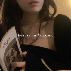 a woman is reading a book with the caption beauty and brains