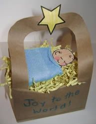 a brown bag with a baby in it and a star on top that says, toy to the world