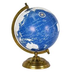 a blue and white globe on a gold stand