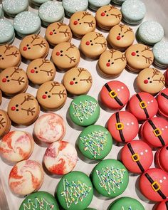 many decorated cookies and pastries on a tray