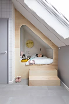 an image of a bedroom with skylights above the bed and stairs leading up to it