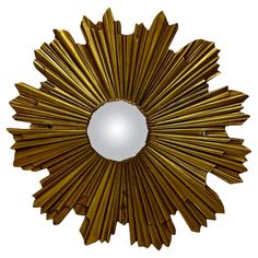 a gold sunburst shaped mirror on a white background