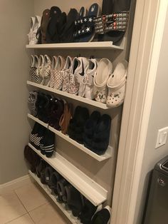 there are many pairs of shoes on the shelves