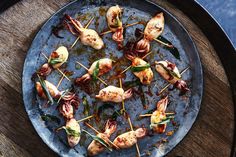 a metal plate topped with food on top of a wooden table