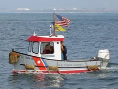 a small boat in the water with an american flag on top