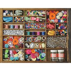 an old wooden box filled with lots of different types of buttons and sewing threads