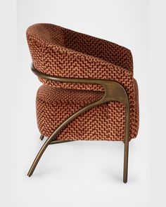 an orange and brown chair with metal legs