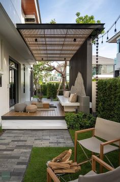 an outdoor living area with wooden furniture and grass