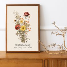 a vase filled with flowers sitting on top of a wooden dresser