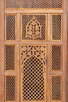 an intricate carved wooden door with lattice design