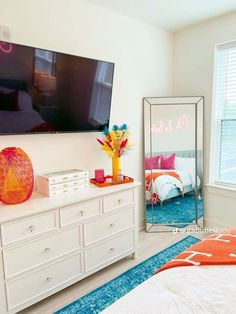 a bedroom with a large flat screen tv on the wall