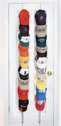 the hat rack has many hats hanging on it's hooks and is organized with baseball caps