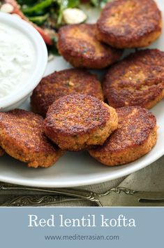 red lentil kofta on a white plate with salad and ranch dressing in the background