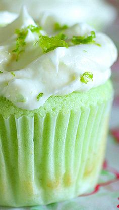 cupcakes with white frosting and green sprinkles