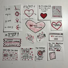 various stickers and decals are arranged on a refrigerator door in the shape of hearts