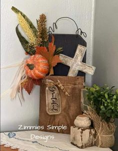 a bag that has some flowers in it and a cross on the front with leaves