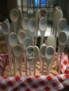 a bunch of spoons that are sitting on a table cloth in a basket with the words good gravy written on them