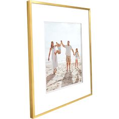 a gold frame with an image of two adults and one child holding hands on the beach