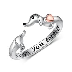 a silver ring with two dogs and the words love you forever written in pink on it