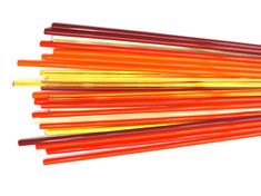 several orange and yellow sticks are stacked on top of each other