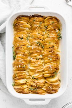 a casserole dish filled with sliced bananas and garnished with parsley