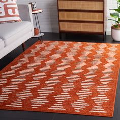 an orange and white rug in a living room