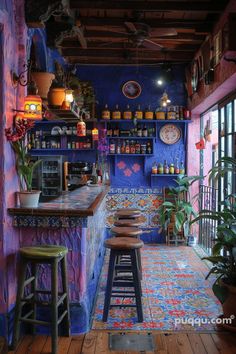 the interior of a brightly colored restaurant with stools