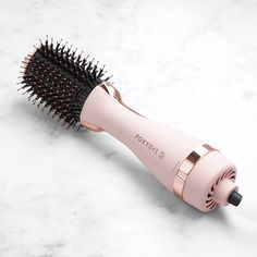 If you're tired of spending hours at the salon for a blowout, the Foxy Bae Baby Blush Blowout Brush is here to save the day! This adorable baby pink tool is not only cute but also incredibly efficient in giving you a salon-quality blowout at home. The ceramic-coated barrel of the brush enables even heat distribution, reducing damage and leaving your hair smooth and shiny. With its 75MM size, this round brush is perfect for creating amazing volume and bouncy curls. Featuring two heat settings, the Baby Blush Blowout Brush allows you to customize the temperature based on your hair type and desired style. The medium setting is ideal for finer hair, while the high setting provides extra heat for thicker or stubborn hair. Say goodbye to frizz and hello to sleek, luscious locks in minutes. Not o Blowout At Home, Ouai Hair Oil, Blowout Brush, Air Dry Cream, Ouai Hair, A Blowout, Pink Tools, Dryer Brush, Air Dryer