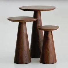 three wooden tables with one sitting on the other