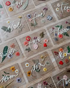 several different types of flowers are arranged on the floor with words written in them to spell out their names