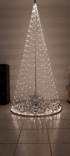 a christmas tree made out of rocks and lights