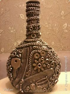 a decorative bottle with an ornate design on the top and bottom is sitting on a table