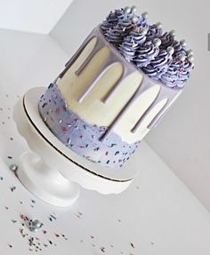 a cake that has been decorated with sprinkles and frosting on it