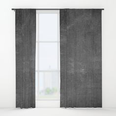 a black and white photo of a window with curtains