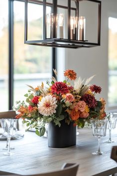 an arrangement of flowers in a vase on a table