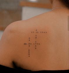 the back of a woman's shoulder with words written on it