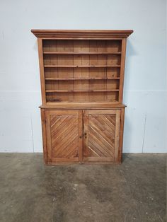 an old wooden bookcase with shutter doors