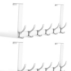 three pairs of white wall mounted toothbrush holders with hooks on each side and one hanging from the ceiling