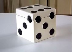 a white and black dice sitting on top of a table