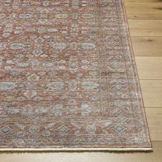 an orange and blue rug on wooden flooring with wood floors in the foreground