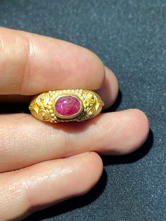 A beautiful gold ring from south east Asia very good condition A beautiful small Ruby light stone is placed in this gold ring The weight of the ring is 4.62 grams we can provide gold certificate as well on request of customers The percentage of gold of this ring is 75 percent which means 18 karat gold we provide fast and free shipping to our customers by which can get the items by maximum 7 working days Gold Hallmarked Sapphire Open Ring, Hallmarked Gold Sapphire Open Ring, Gold Sapphire Ring Open Ring Hallmarked, Antique Gold Emerald Cabochon Ring, Traditional Gold Oval Ruby Ring, Traditional Ruby Ring In Yellow Gold, Traditional Yellow Gold Ruby Ring With Gemstone, Classic Gold Ruby Signet Ring, Traditional Oval Ruby Ring In Gold