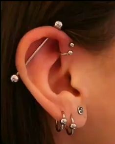 an ear with several piercings attached to it