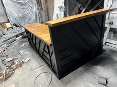 a black and wood bar sitting on top of a floor