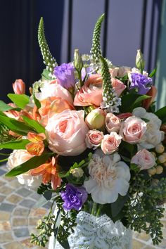 a vase filled with lots of flowers on top of a table