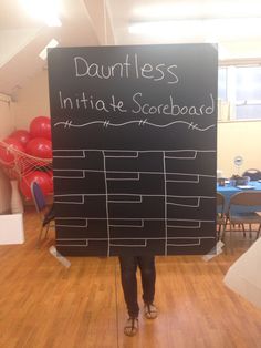 a person standing in front of a blackboard with writing on it that says, dauntless intimate scrobaad