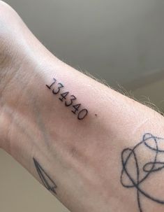 a person's arm with a tattoo that reads, dearly on the wrist