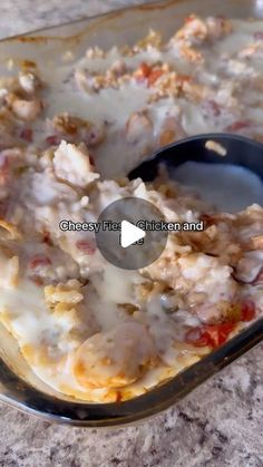 a casserole dish with meat and cheese in it on a counter top next to a spoon