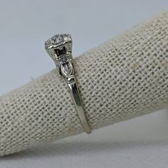 "A true classic 1950s engagement ring! This mid century vintage engagement ring features an antique cut diamond in a likely mix of generations of brides. The 1950s ring is crafted in 14k white gold and sparkles with a .41ct old European cut diamond (grade H-I/SI1). The round-cut center diamond is set into a square 'illusion' setting for a \"modern\" look. The simple design is accented with two single-cut diamonds weighing approximately .04cttw. This ring is a petite size 5.25 but can be resized Vintage Single Cut Diamonds Brooches For Gift, Antique Single Cut Diamond Ring Gift, 1950s Engagement Ring, 1950s Ring, Square Illusion, European Cut Diamond Engagement Ring, Vintage Engagement Ring, Mid Century Vintage, European Cut Diamonds