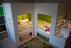 there are two bunk beds in the room with green and white decor on each bed